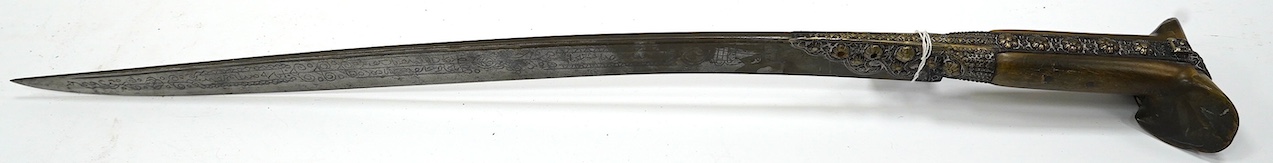 A 19th century Turkish Yataghan, blade inlaid with extensive inscriptions, embossed hilt, two piece horn grips, blade 55.5cm. Condition - good